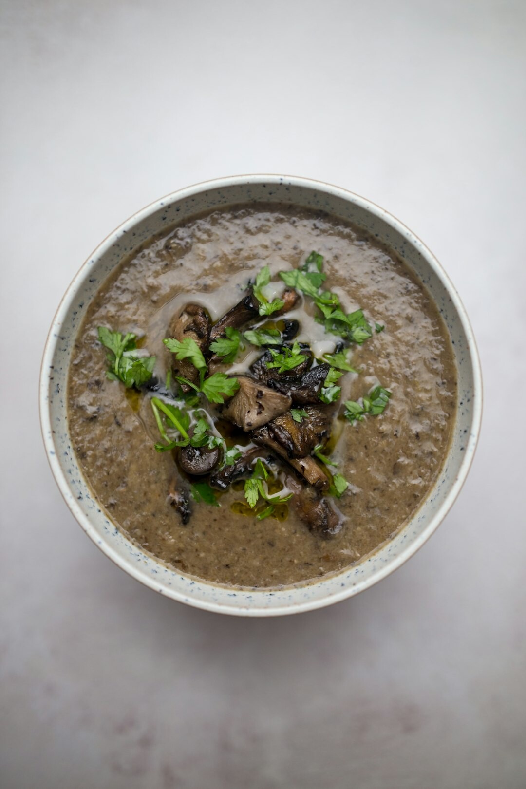 Bowl of creamy mushroom soup with autumn vegetables