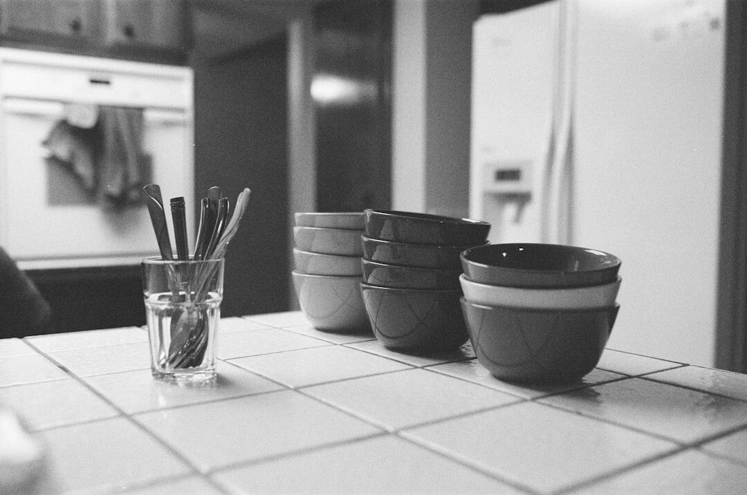 Notebook and pen on kitchen table with coffee cup