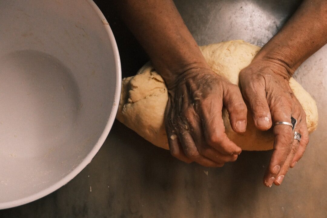 Woman kneading dough in a home kitchen